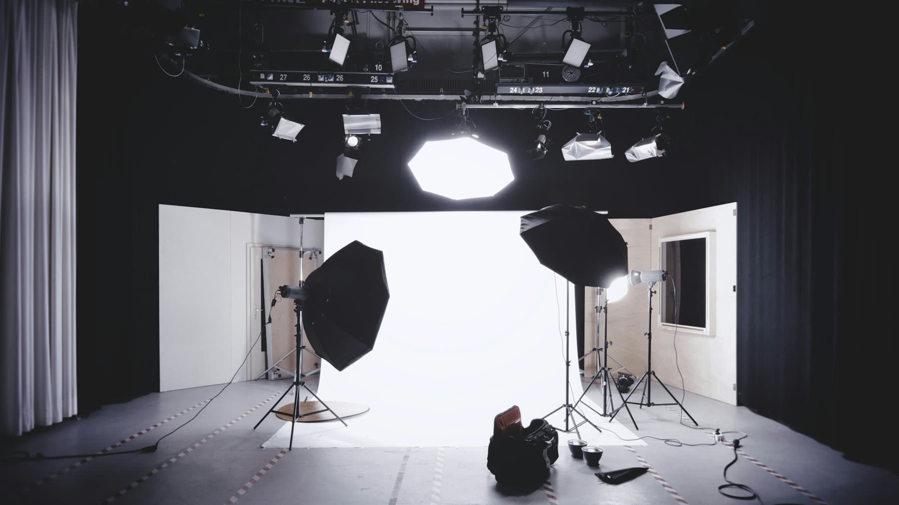 Cinematic Basil Studios photography stage — full lighting rig over a blank cyclorama